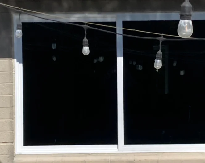 A close up view of two windows with blacked out panes.