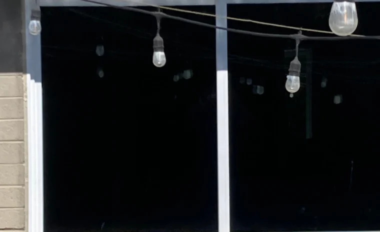 A close up view of two windows with blacked out panes.